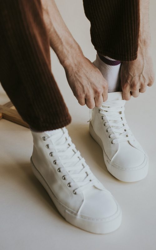 model-putting-on-sneaker-studio-shoot.jpg